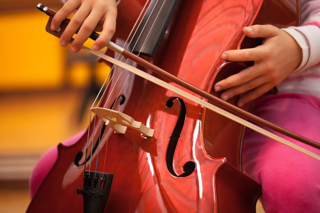 Detail of a child playing the cello Detail of a child playing the cello
