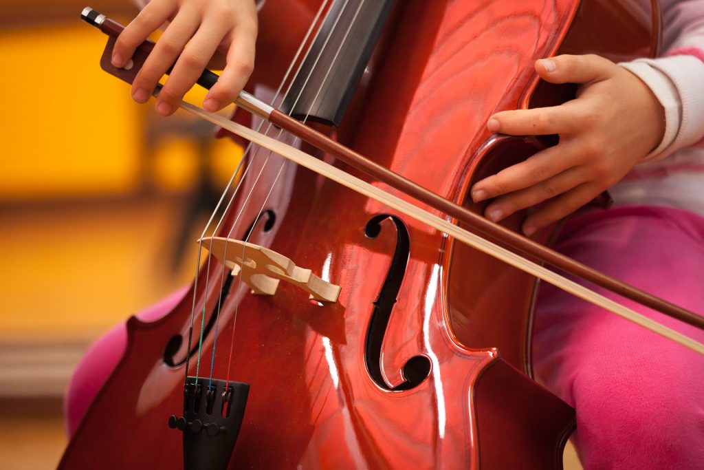 Detail of a child playing the cello