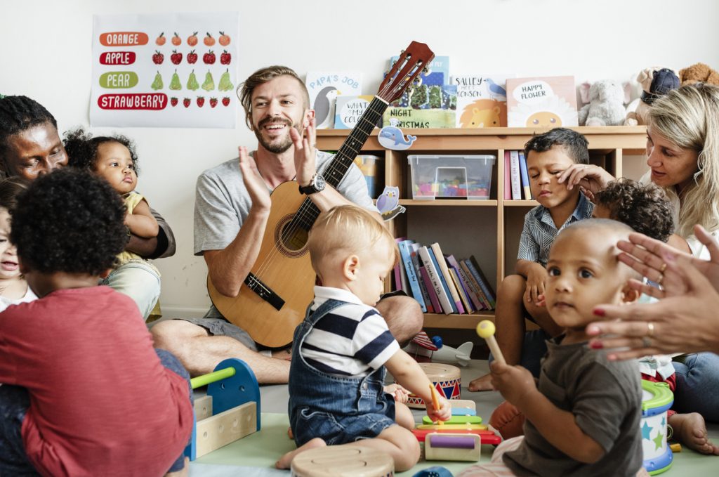 Nursery children playing with musical instruments in the classroom Musically Minded - classes for children birth-5