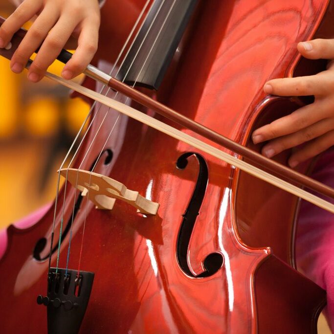 Detail of a child playing the cello Detail of a child playing the cello