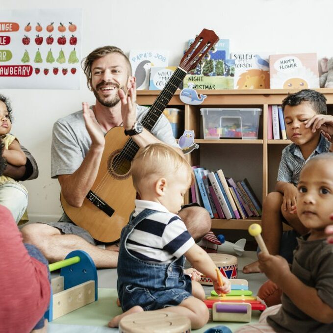Nursery children playing with musical instruments in the classroom Musically Minded - classes for children birth-5